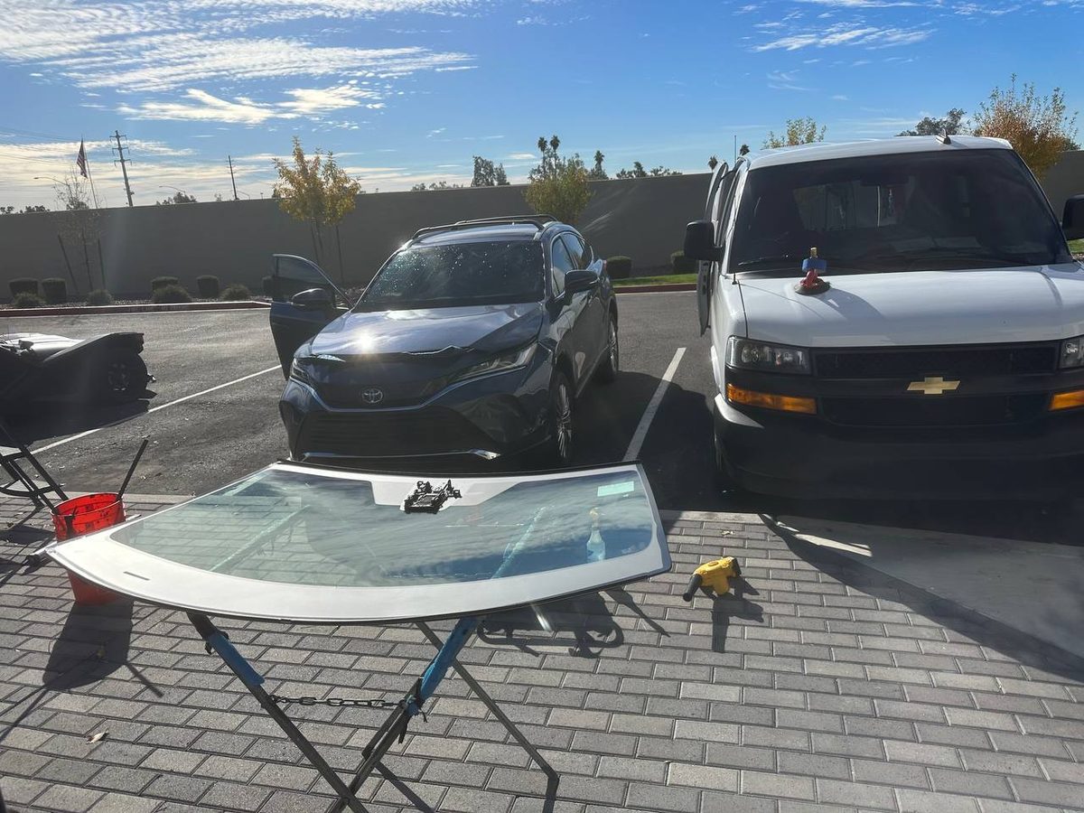 Technician finishing a windshield installation
